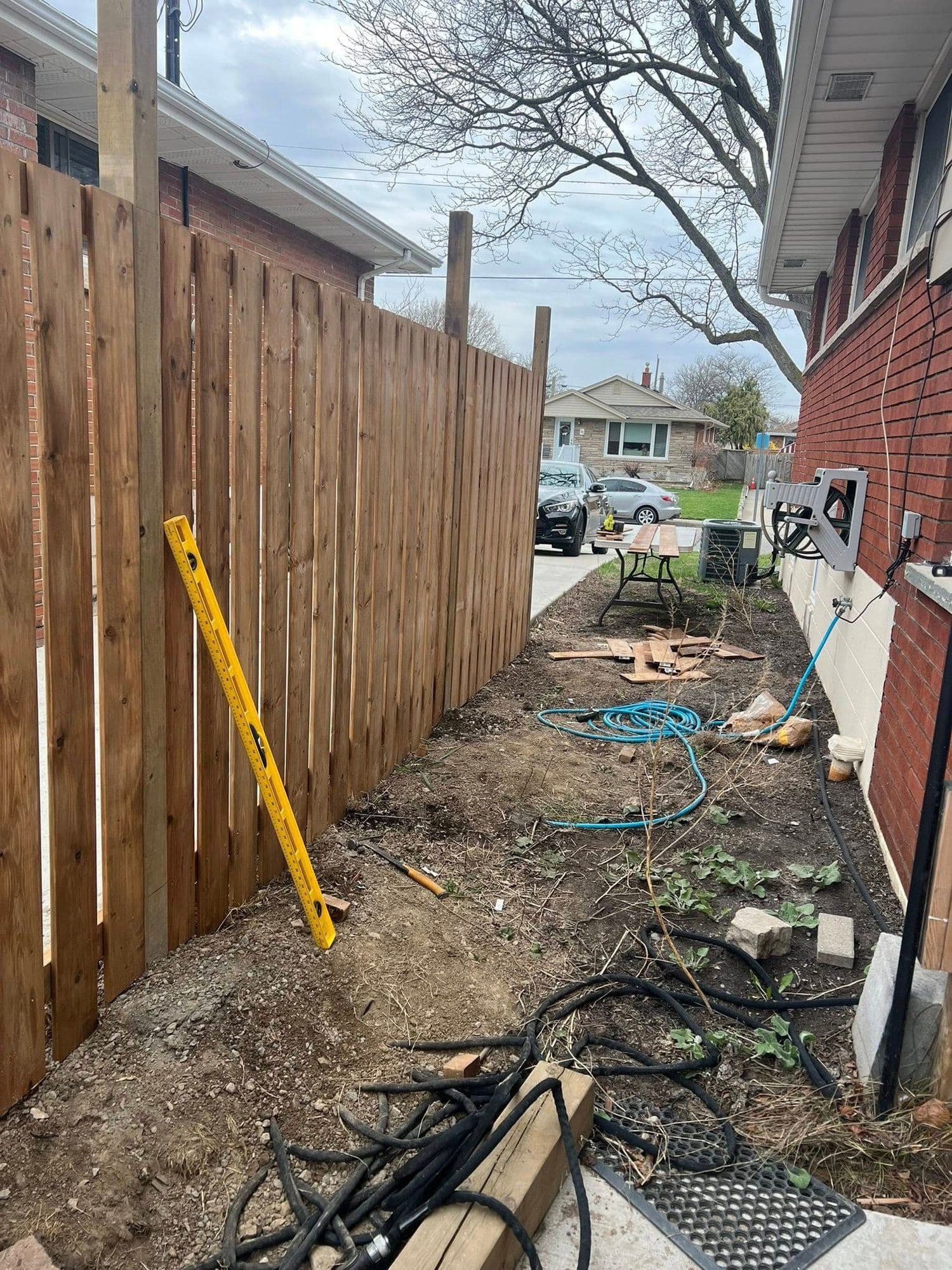 Vertical board cedar privacy fence after staining