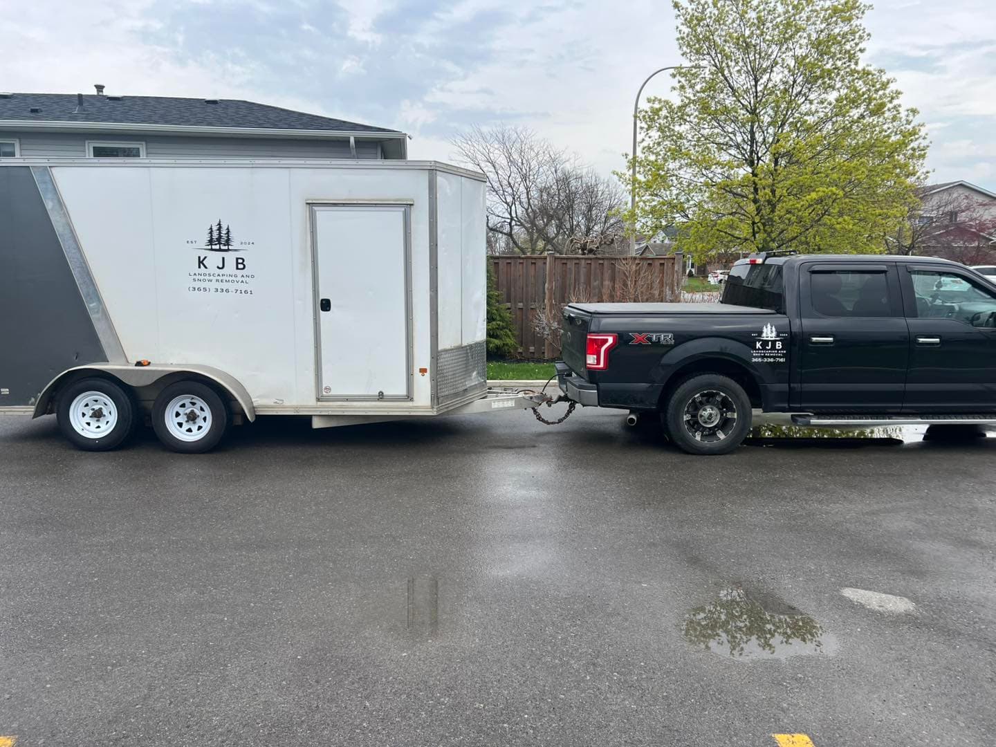 KJB Landscaping work truck and branded enclosed trailer parked ready for a job